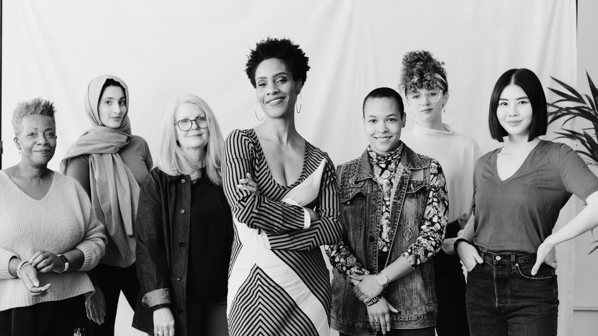 Black and white photo of a diverse group of women standing together.